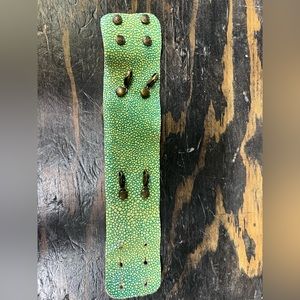 Bracelet wraps and buttons. Can add charms. Textured band